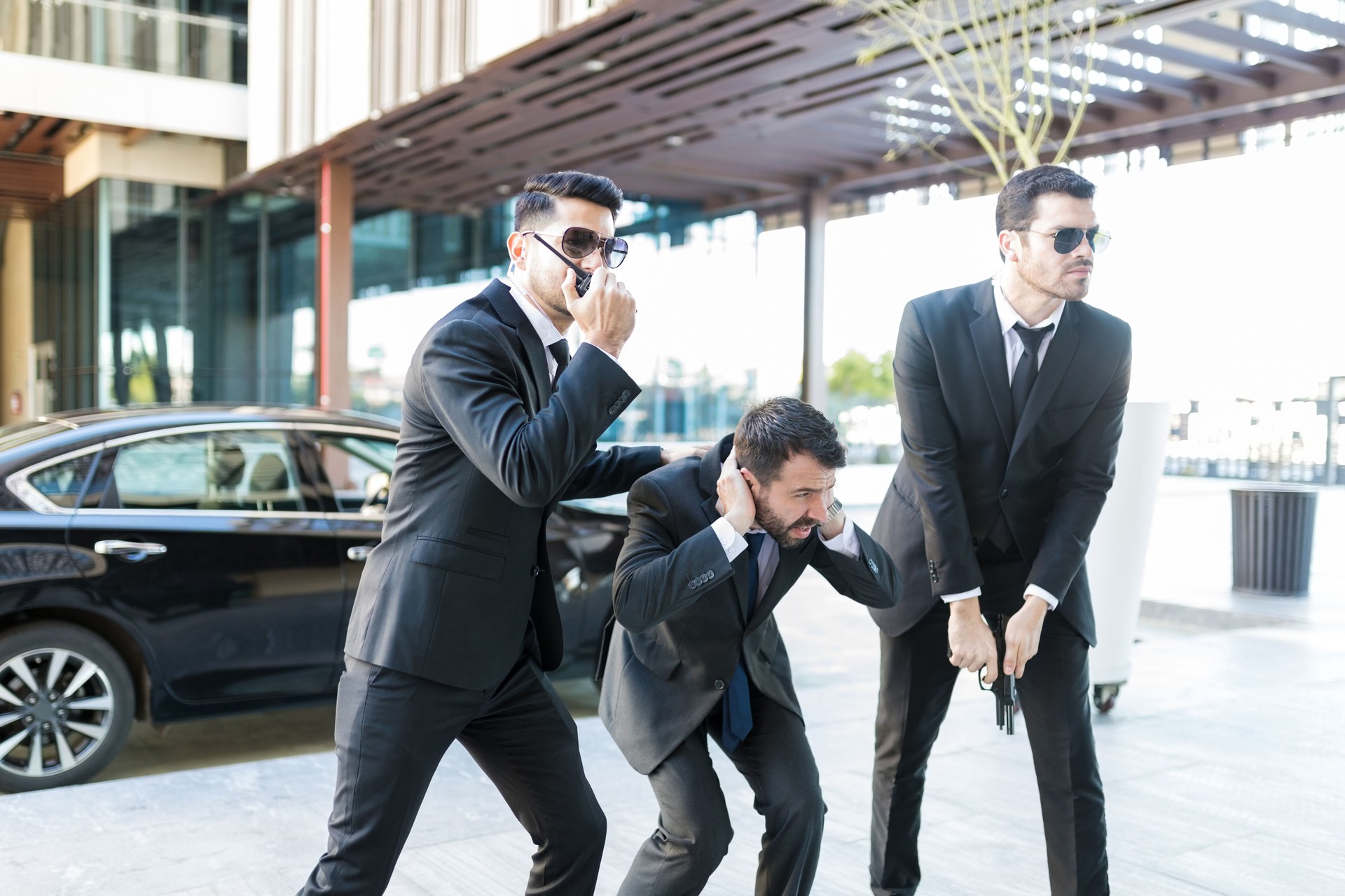 Bodyguards Safeguarding Scared Boss From Attack