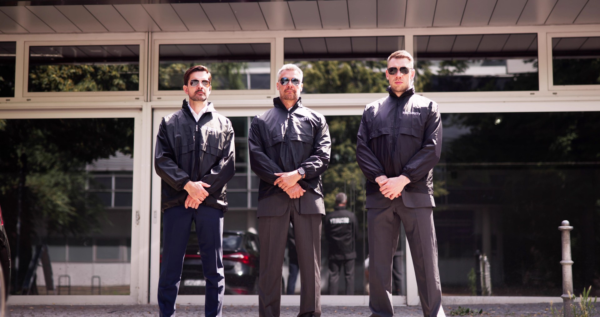 Professional security guard overseeing event safety with his team of bodyguards