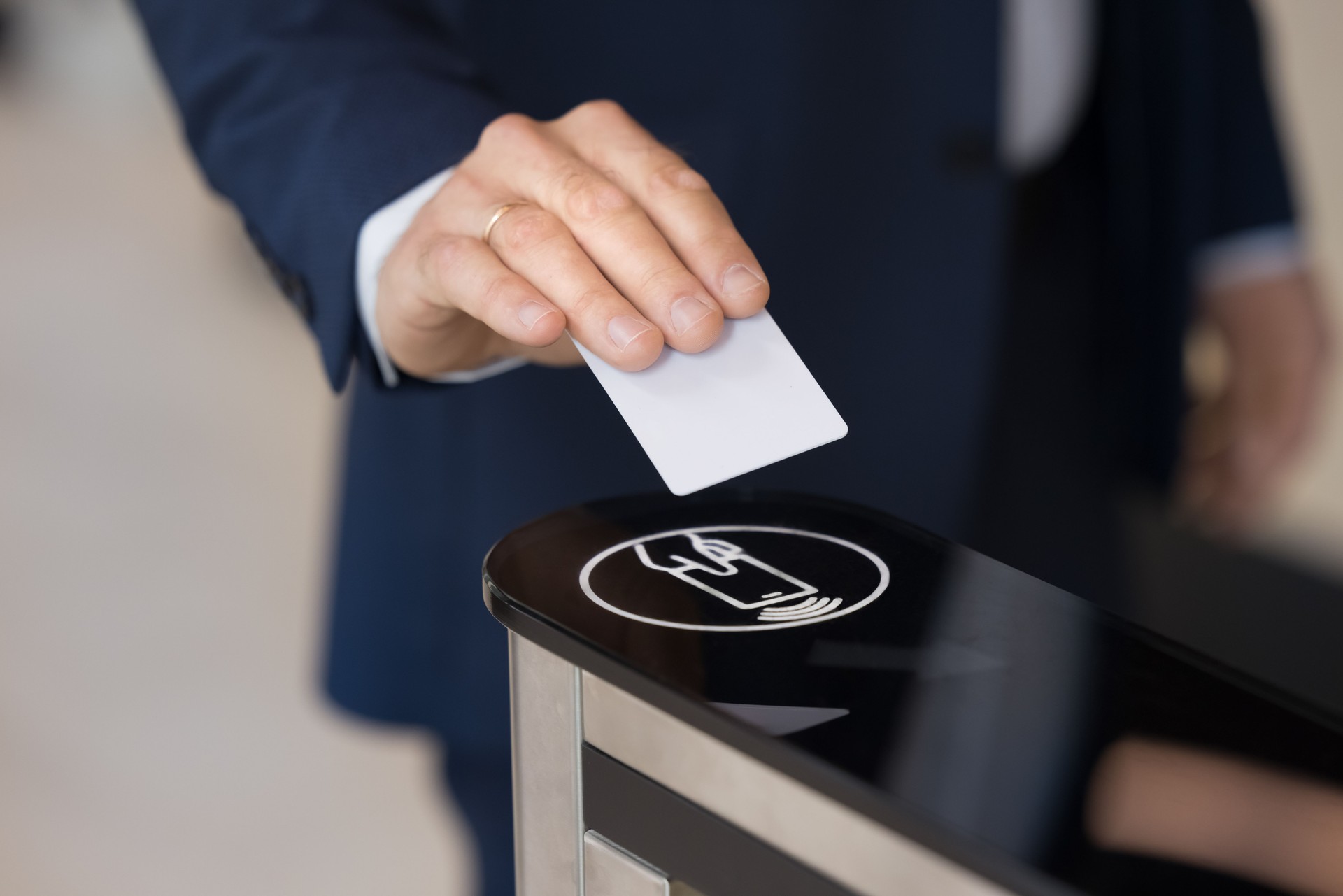 Business man holding electronic keycard at sensor control keypad