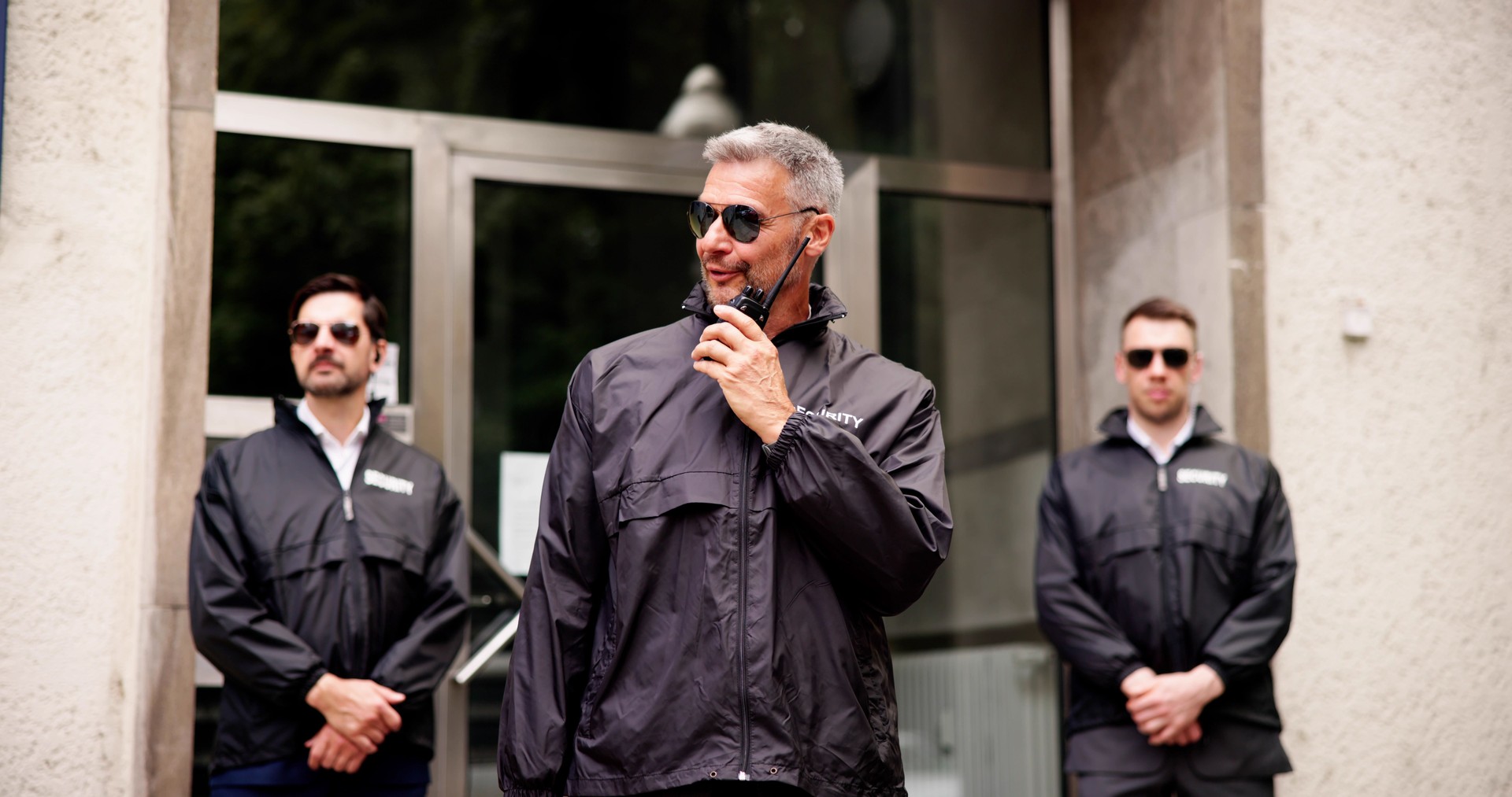 Diligent Security Guard Ensures a Handsome Businessman's Safety Outside